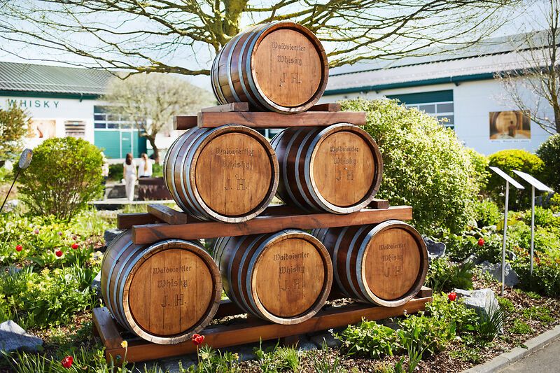 Pyramid-shaped wooden barrels in the garden of the Haider whisky experience.