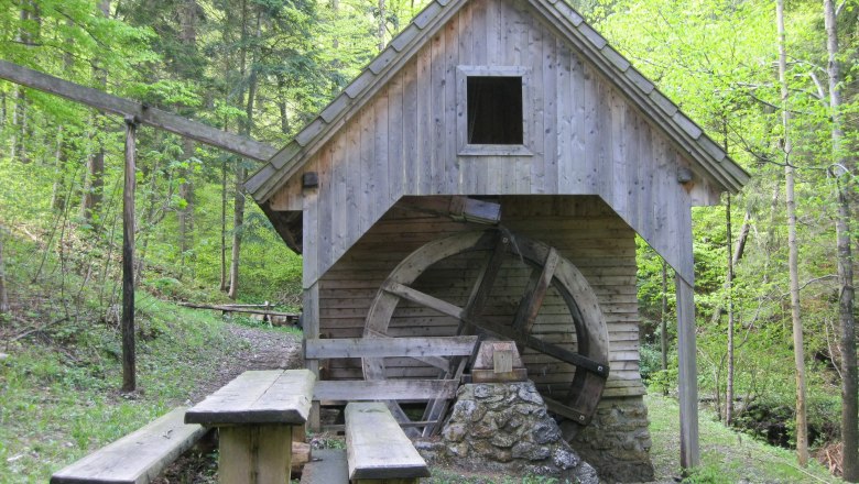 Wooden mill with water wheel in the forest