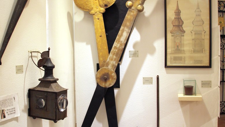 Exhibit in the Stockerau District Museum with old clock parts and drawings.