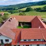 Aerial view of a farm with courtyard and surrounding landscape.