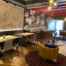 Modern restaurant with stylish furnishings and decorative elements on the wall.