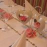 Festively laid table with heart decorations and rose petals.