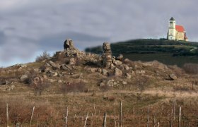 Landscape with rock formations and church in the background.
