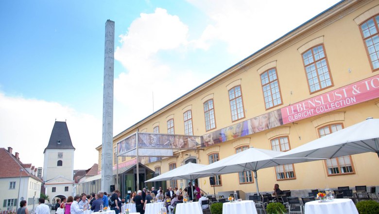 Exterior view of the Kunsthalle Krems with people at an event.