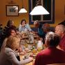 Group of people having breakfast in a cozy room.
