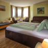 Room with double bed and sofa