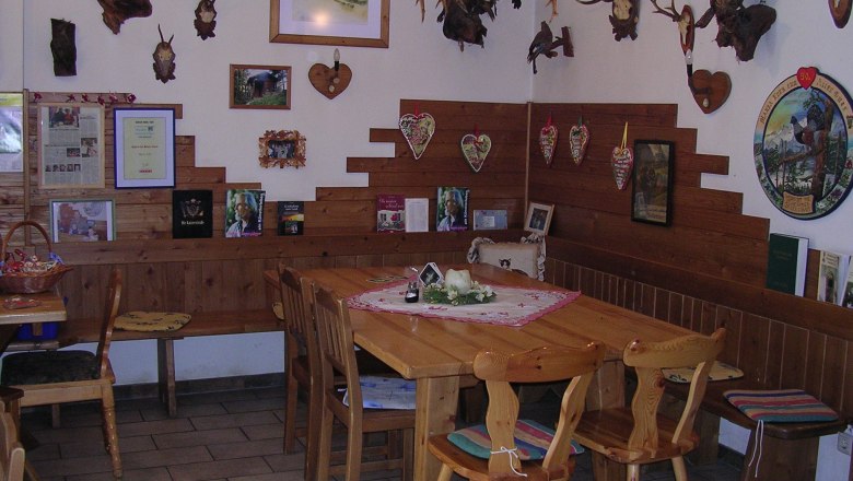 Cozy parlor with wooden furniture and hunting trophies on the walls.
