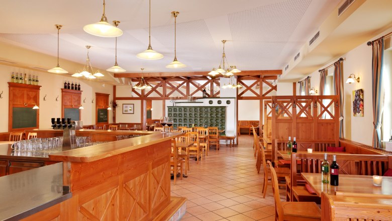 Interior view of a wine tavern with wooden furniture and tiled floor.