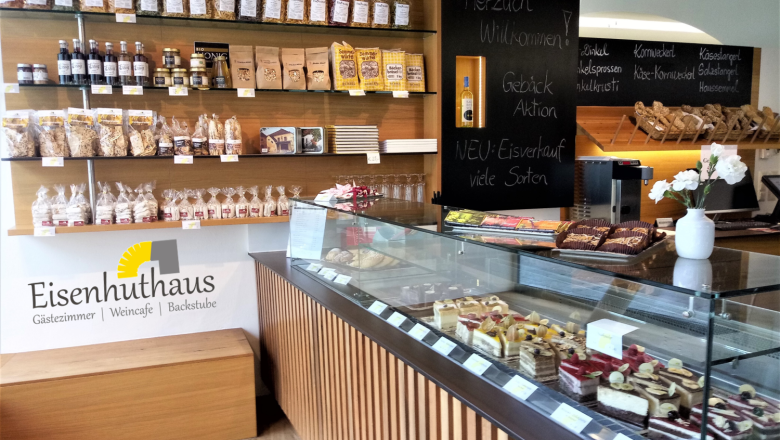 Interior view of a store in the Eisenhuthaus with pastries and cakes in a display case.