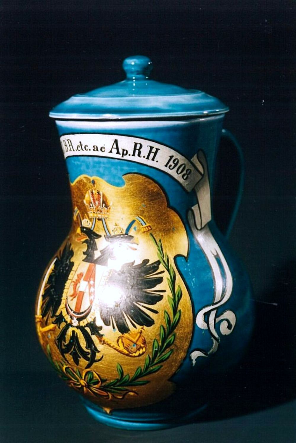 A decorated jug with imperial coat of arms and inscription from 1908.