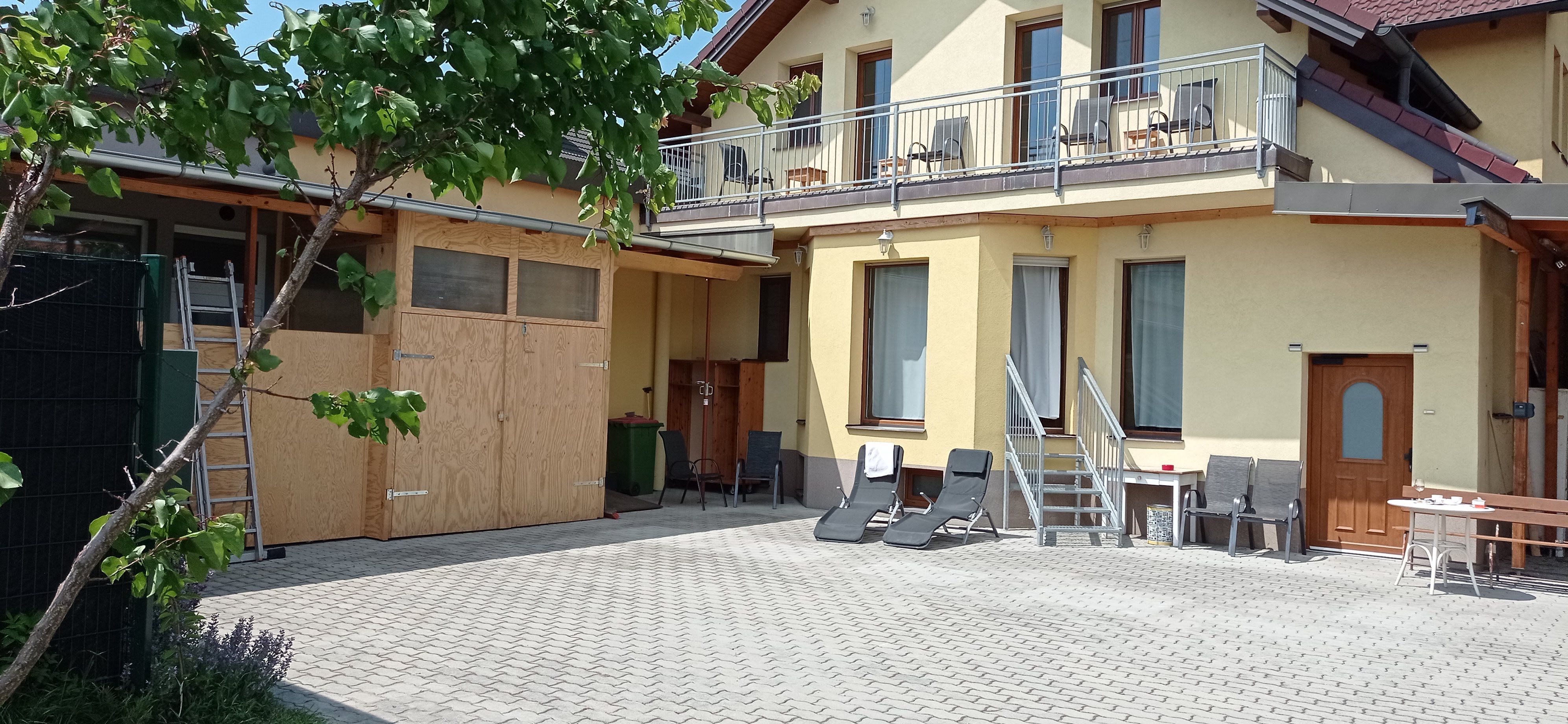 House from the outside with yellow façade and balcony 