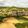 Aerial view of Falkenstein with fields, vineyards and a castle on a hill.