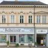 Façade of a two-storey building with the lettering 'Scheinerhaus'.