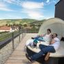 Family relaxing on a terrace with a view of the rural landscape.