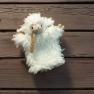Hand puppet made of sheep's wool on a wooden background.