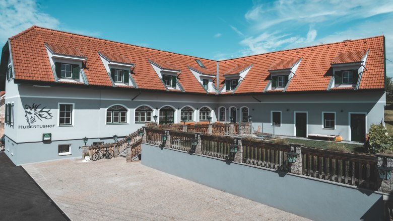 Hubertushof, © Matthias Auer A building with red roof tiles and several skylights, labeled 'Hubertushof'.
