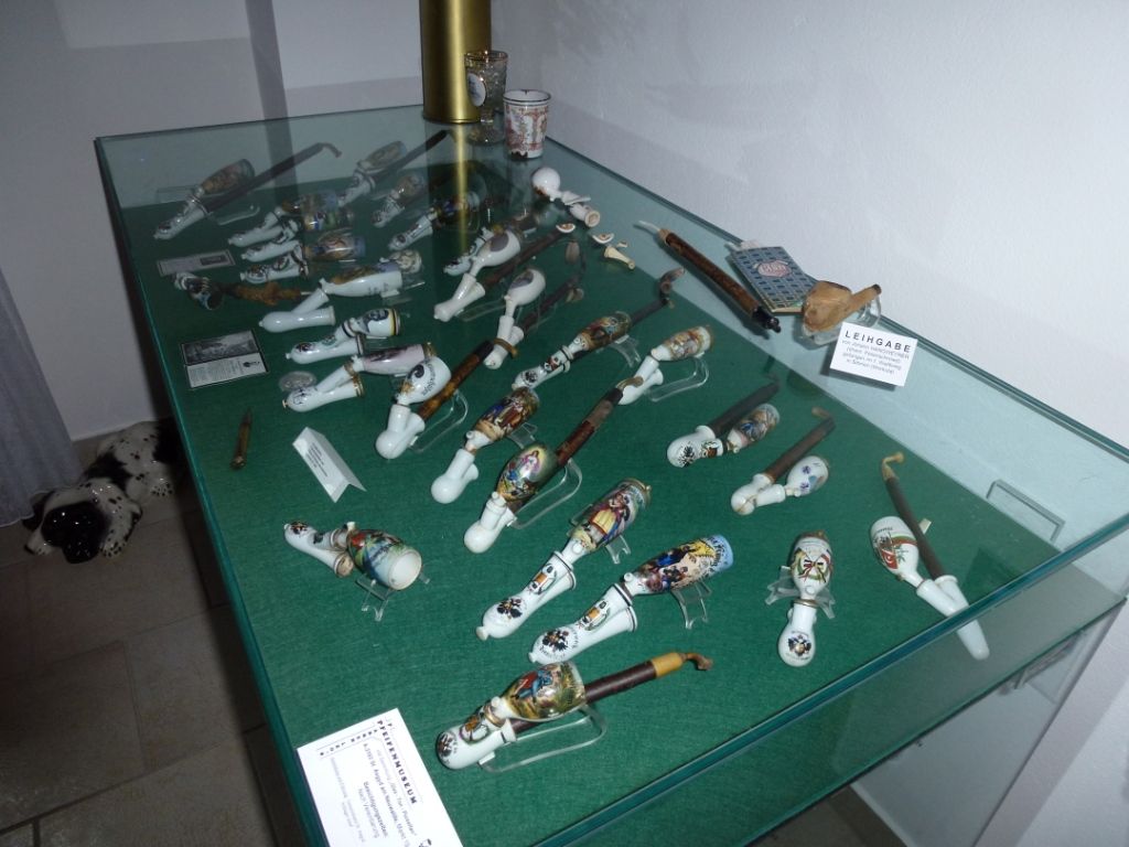 Display case with decorative pipes in a museum.