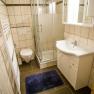 Bathroom with shower, washbasin, WC and towel radiator.