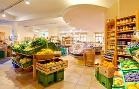 Interior view of an organic store with fresh fruit and vegetables.
