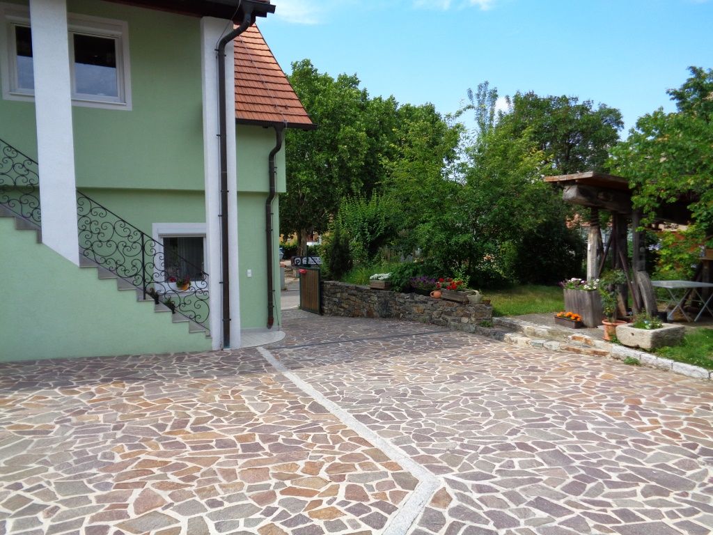 Inner courtyard with paved floor, green house and garden.