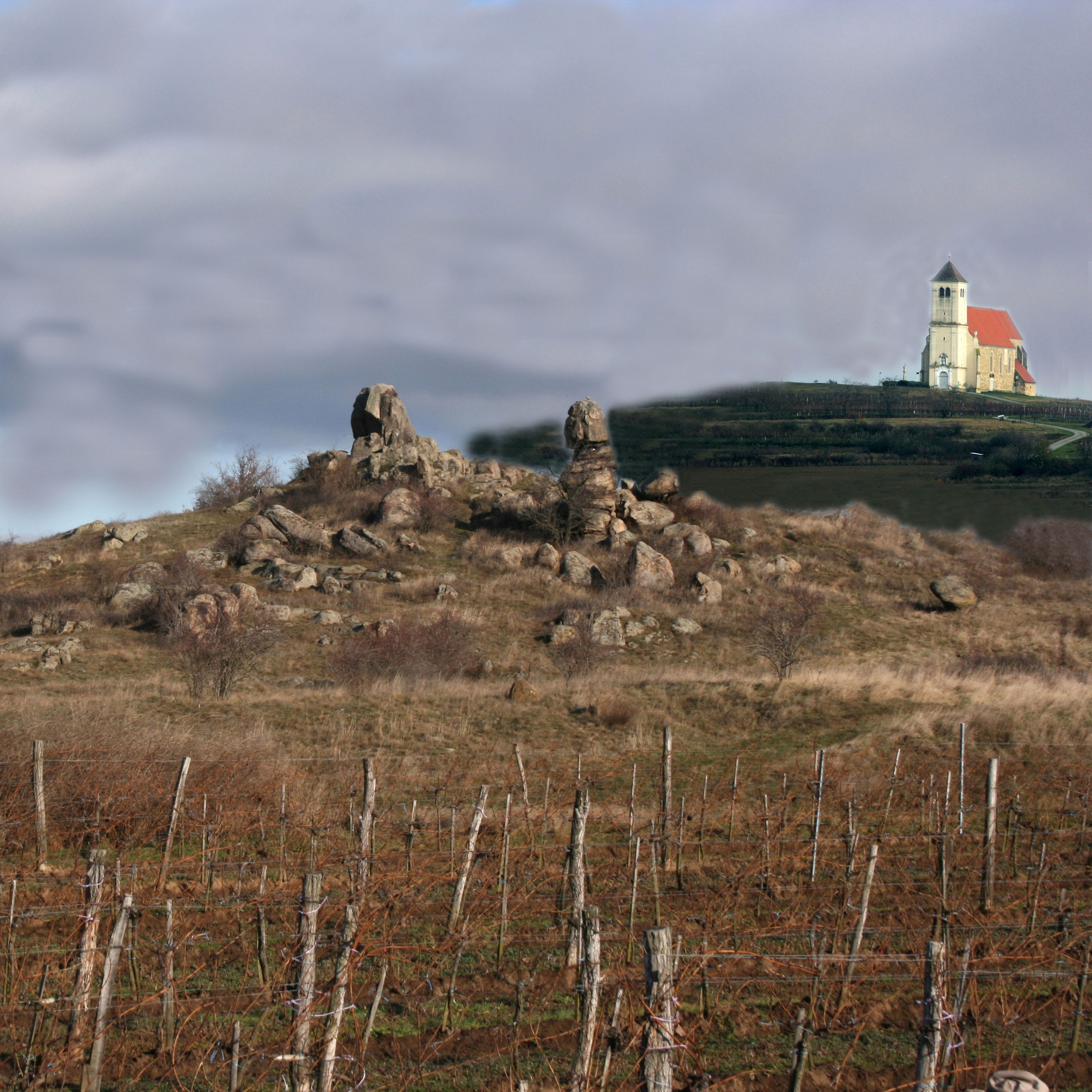 Landscape with rock formations and church in the background.