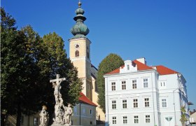 Church with onion dome and parish office in Gaweinstal, Austria.