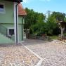 Inner courtyard with paved floor, green house and garden.