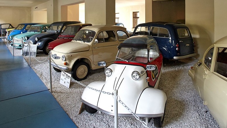 A collection of classic cars in an automobile museum.