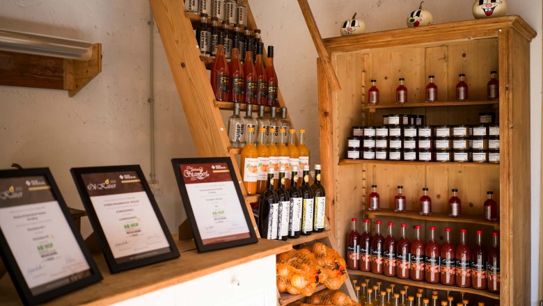 Various award-winning products presented on wooden shelves