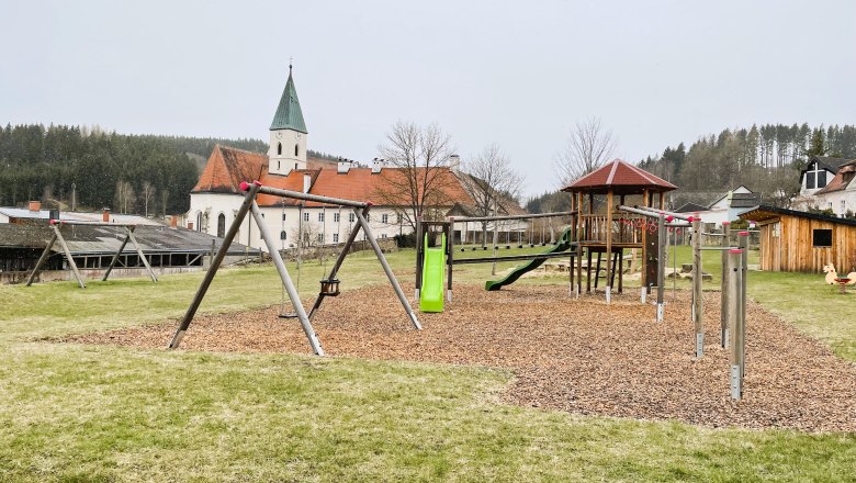Playground with church in the background in Sch&ouml;nbach