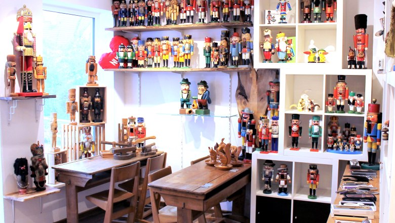 Room with nutcracker figures on shelves and tables.