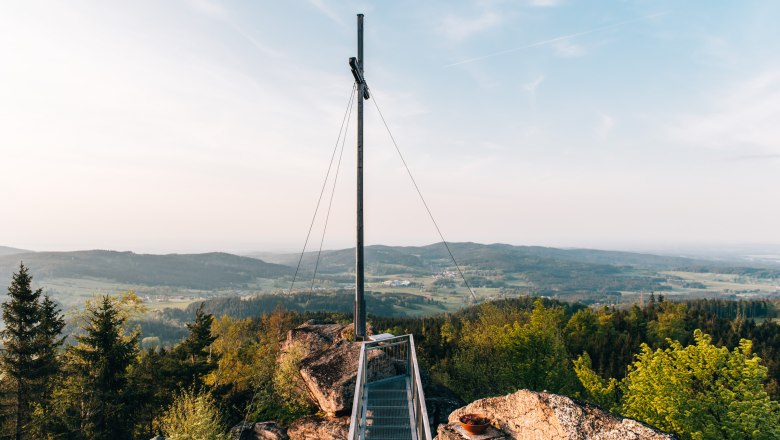 Viewing platform with summit cross on the Nebelstein, surrounded by forest and hills in the Waldviertel.