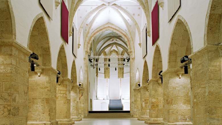 Interior view of the Minorite Church in Krems with Gothic arches and modern lighting.