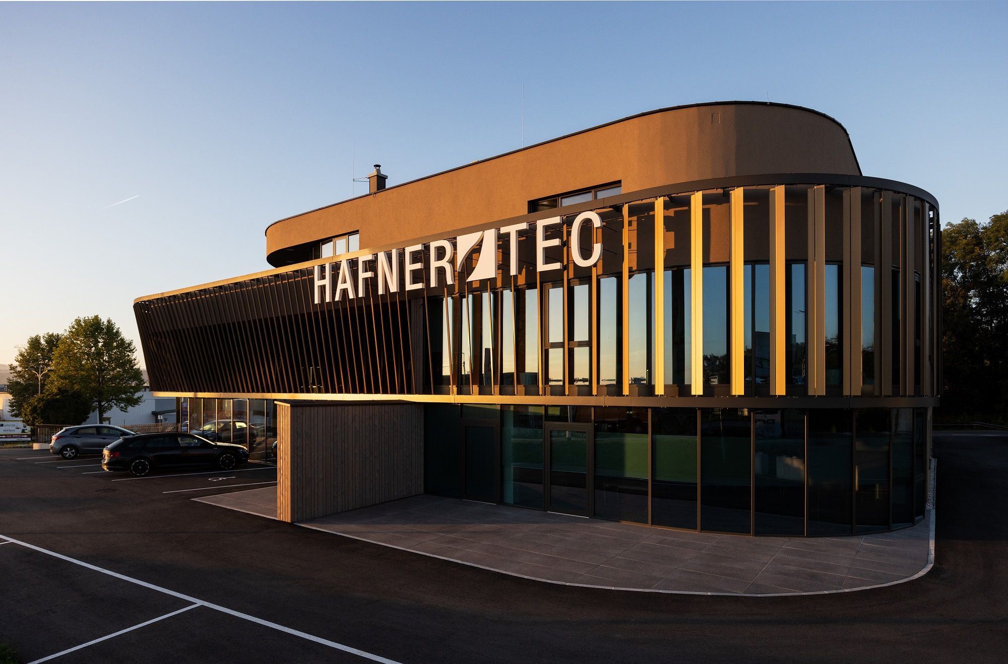 Modern building with the inscription 'HAFNER TEC' at sunset.