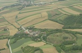 Aerial view of a rural landscape with fields and a small village.