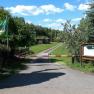 Entrance to a campsite with barrier and registration sign.