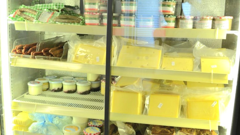 Fridge with various dairy products, meat and eggs.