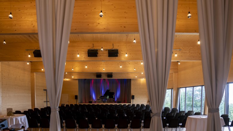 Event hall from behind with seating and stage
