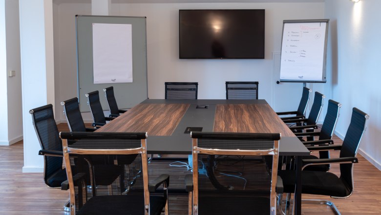 Seminar room with table and chairs and screen