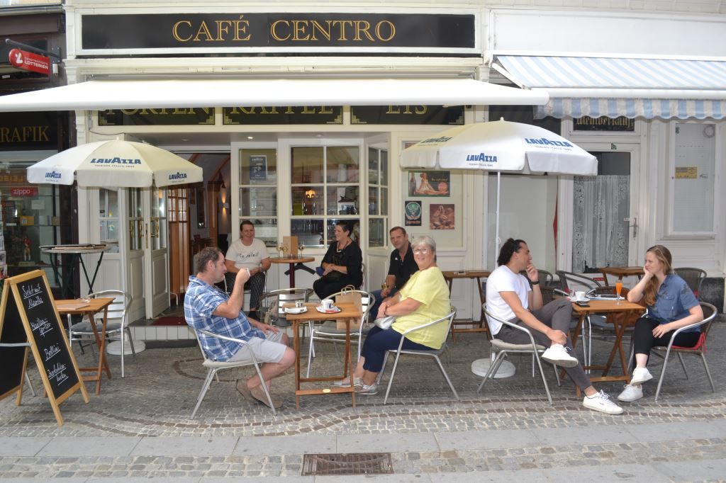 People sit in front of a café called Café Centro.