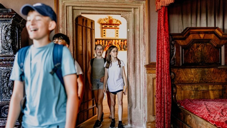 Children enter a room in a Renaissance castle.