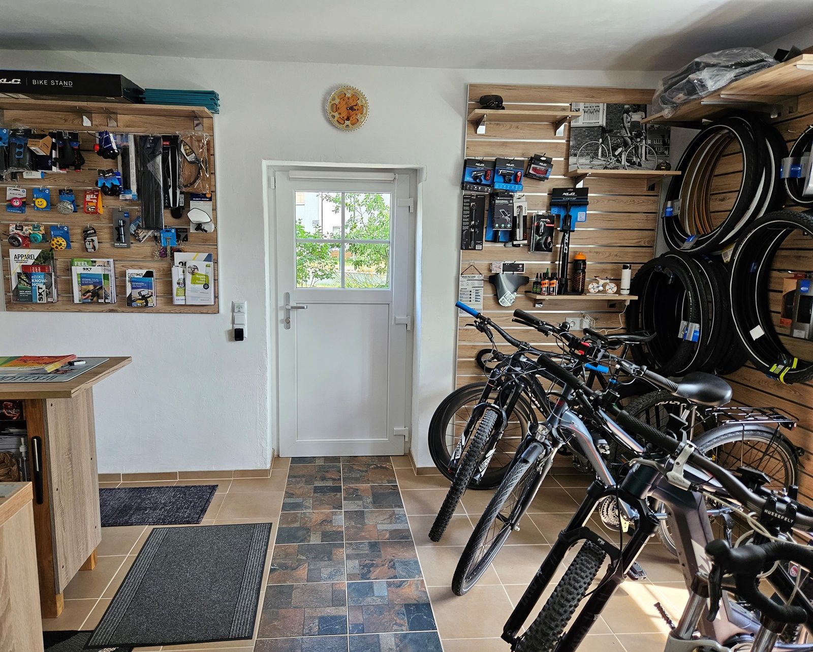 Interior view of a bicycle workshop with bicycles and accessories on the walls.
