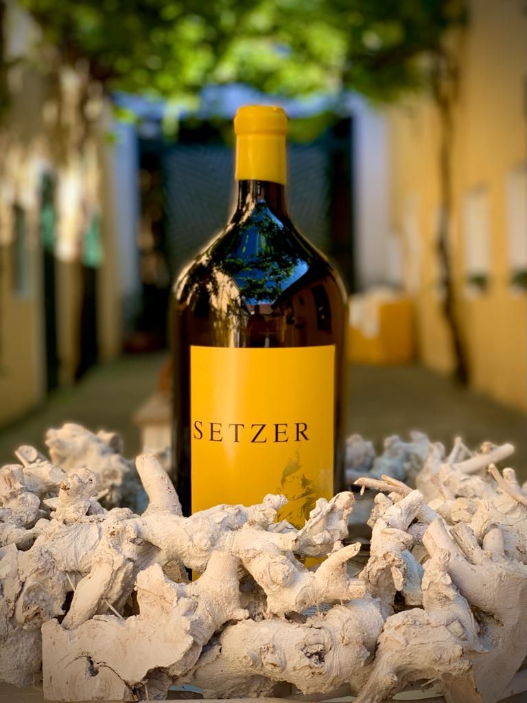 Magnum bottle of Setzer wine in a decorative setting with pieces of wood.