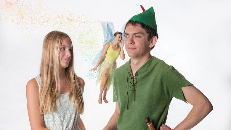 Three people in Peter Pan costumes, one dressed as Peter Pan, one as Wendy and one as Tinkerbell.