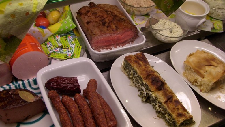 Various dishes on a buffet, including meat, sausages and strudel.