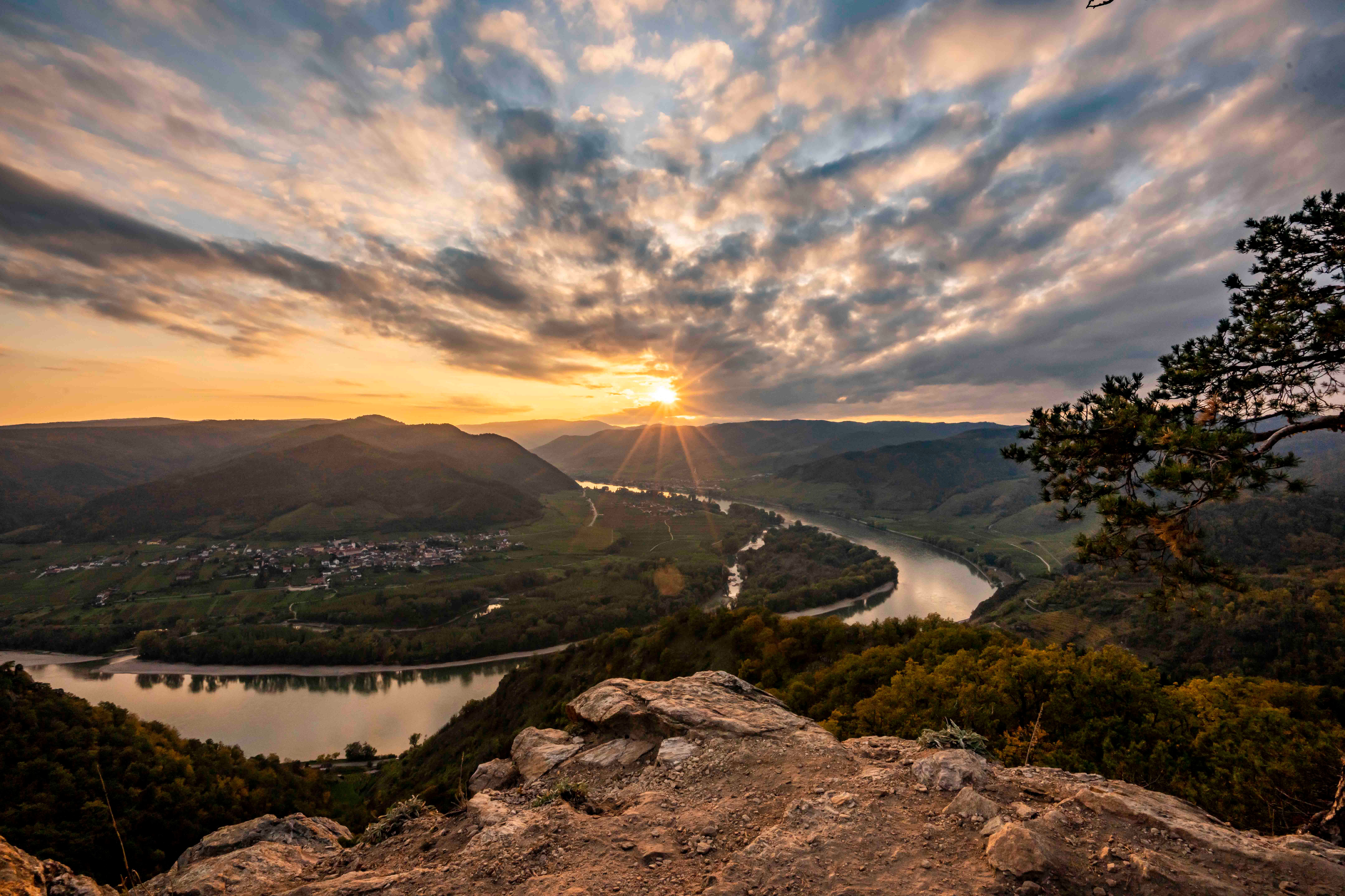 Sunset over the Danube in Dürnstein, with a view of the river and hills.