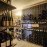 A wine cellar with shelves full of wine bottles neatly stacked.