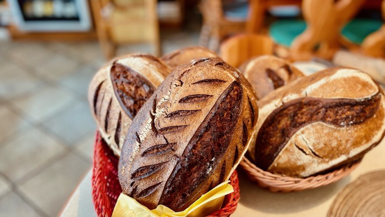 Freshly baked bread in baskets on a table.