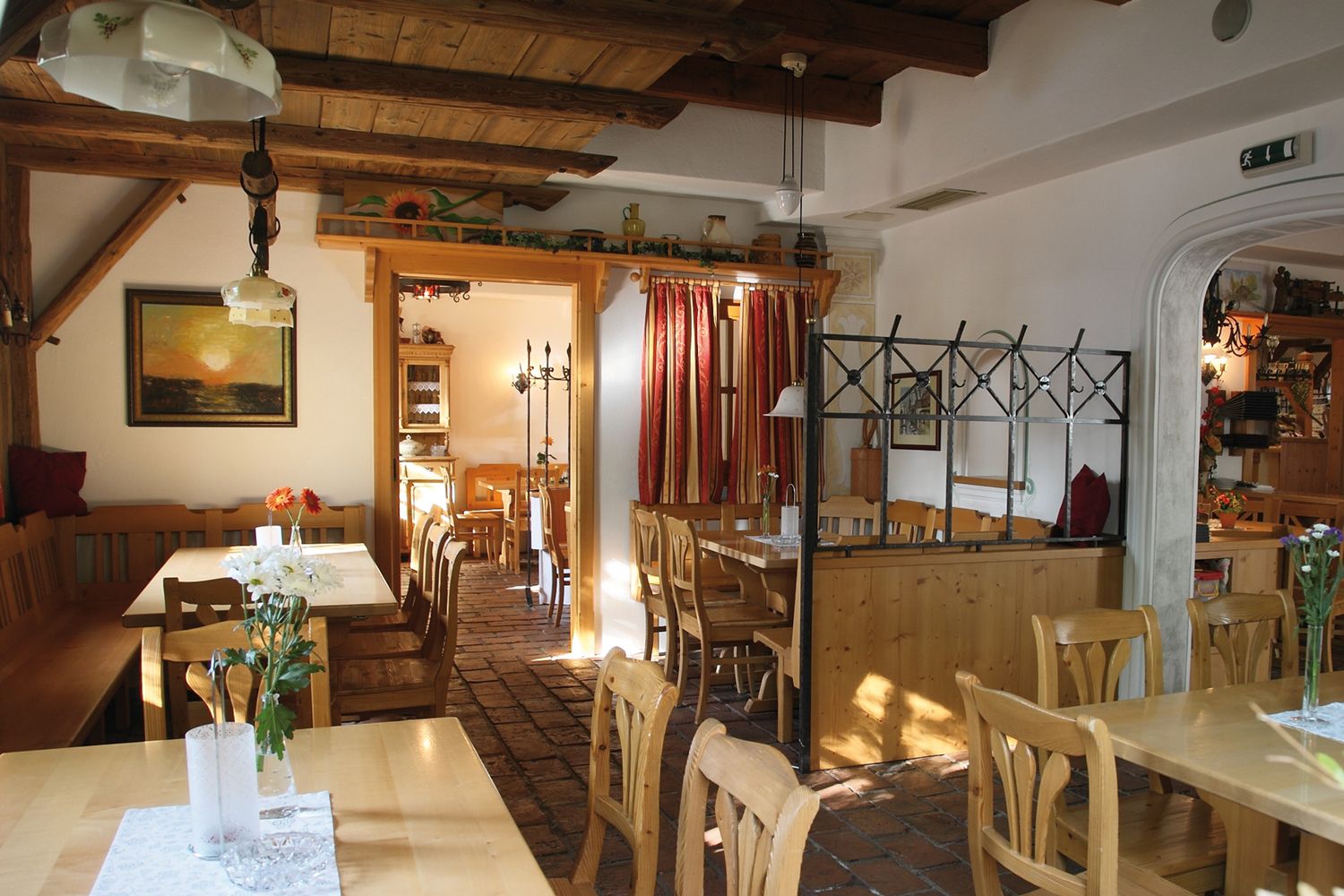 Interior view of a cozy wine tavern with wooden furniture and rustic decoration.