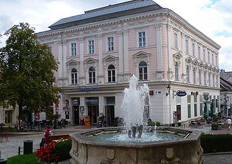 Historic building with fountain in the foreground.
